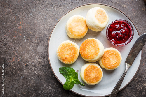 Cottage cheese pancakes with jam and mint  top view. Healthy Breakfast.