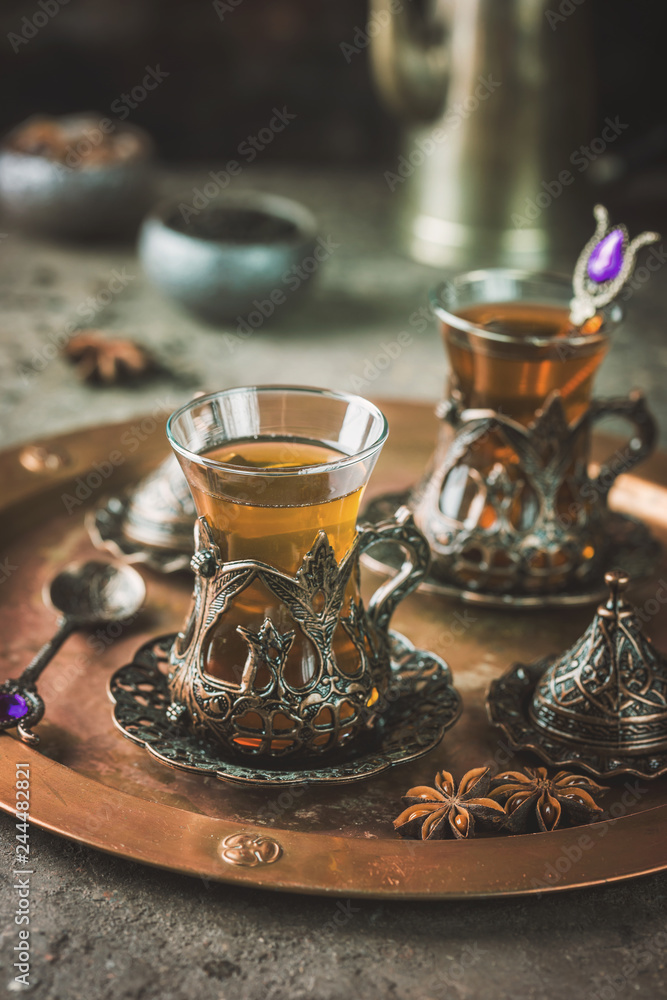 Fototapeta premium Turkish tea in traditional glass on tray closeup