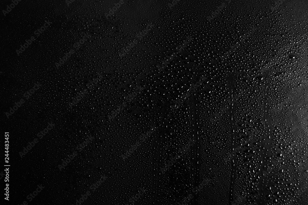 Obraz premium Drops of water on a dark glass texture background