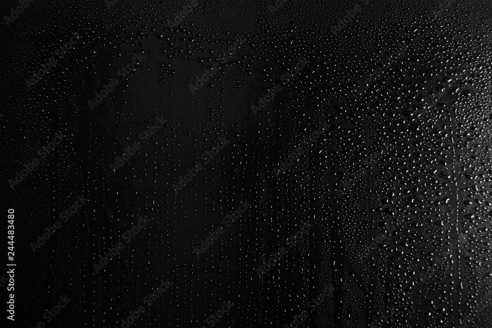 Drops of water on a dark glass texture background