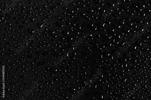 Drops of water on a dark glass texture background © Cosminxp