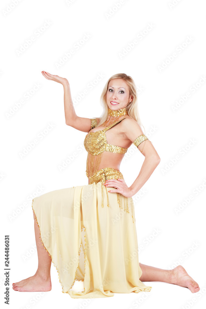 Naklejka premium Beautiful blonde bellydancer in golden-yellow costume over white background