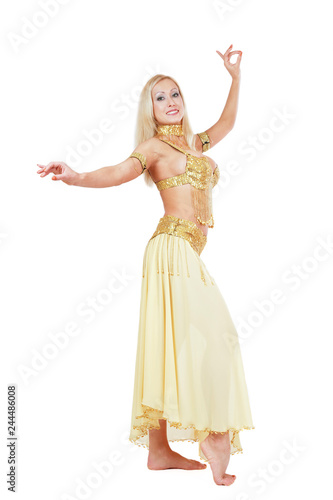 Beautiful blonde bellydancer in golden-yellow costume over white background