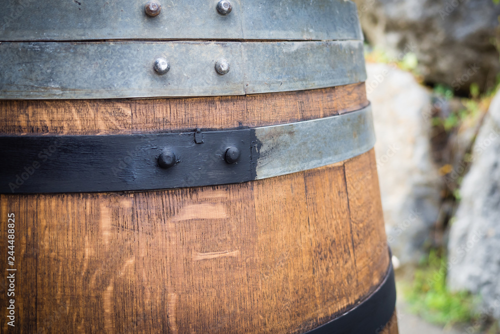 Barrel restoration, a man painting an old wine barrel. Half barrel for plants and garden. Barrel restoration, a man painting an old wine barrel. Half barrel for plants and garden.