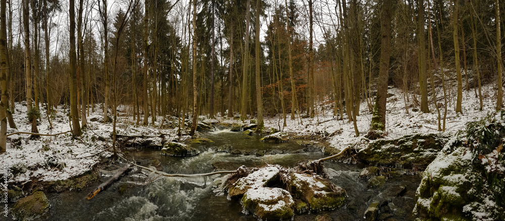 smooth motion of wild water in a river in winter with snow and ice on rocks and stones in the beautiful nature of a forest smooth motion of wild water in a river in winter with snow and ice on rocks and stones in the beautiful nature of a forest
