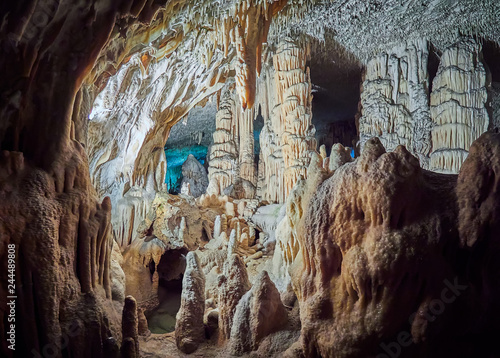 View of stalactites and stalagmites in an underground cavern - Postojna cave in Slovenia photo