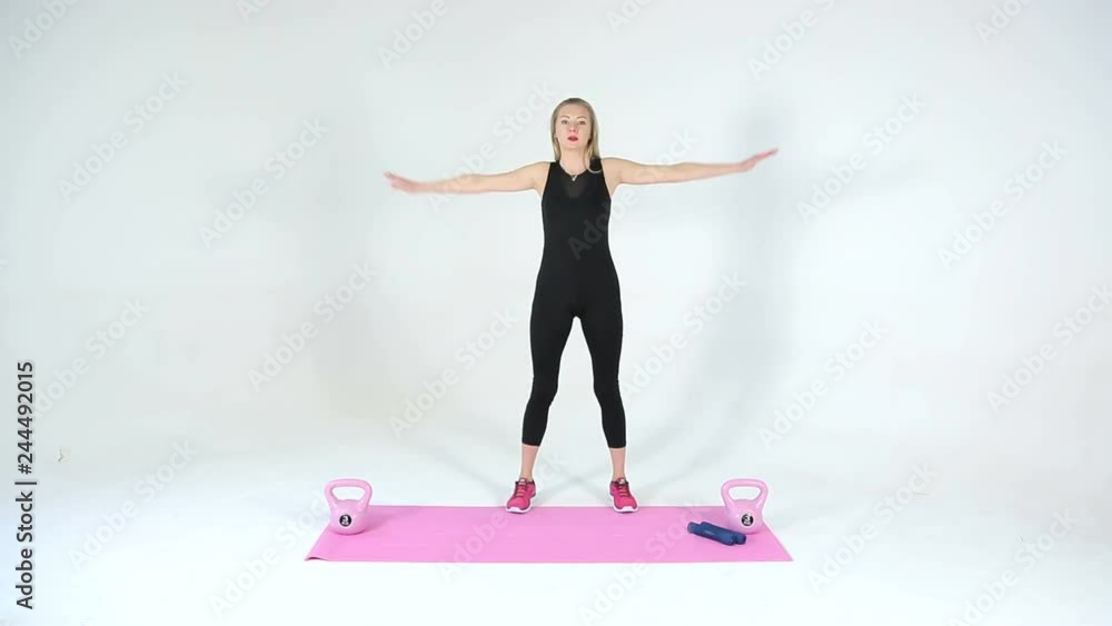 The girl shows yoga exercises on a white background
