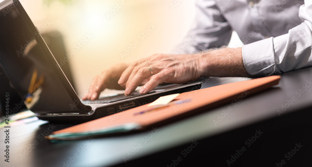 Hands using a laptop, light effect