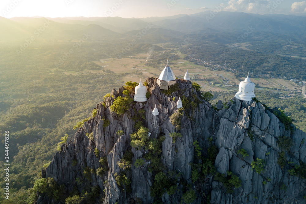 Naklejka premium Spectacular aerial view of floating pagodas on the mountain cliff at Wat Chaloem Phra Kiat in Chae Hom District, Lampang province, Thailand.