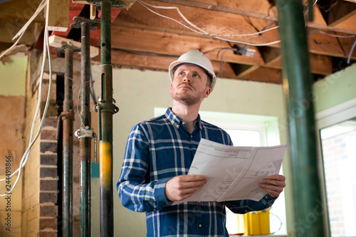 Bilde på lerret Architect Inside House Being Renovated Studying Plans