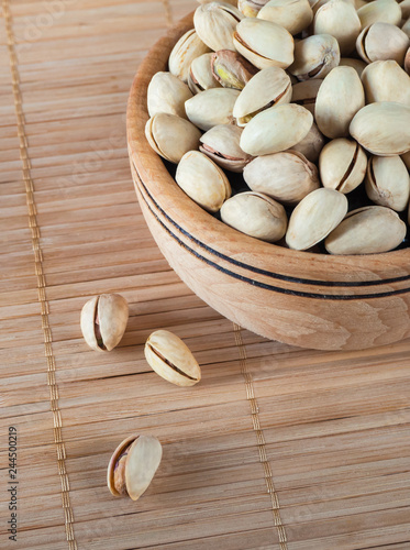 Pistachios in a wooden bowl. 