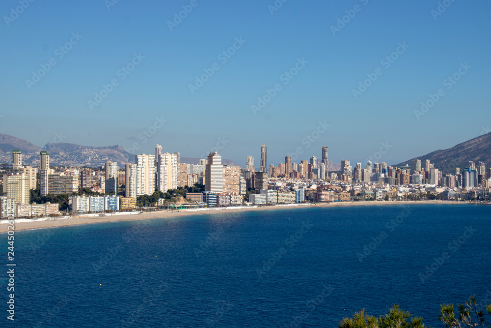 Aerial photo taken in Benidorm in Spain Alicante, showing the beautiful beach of Playa Levante and hotels, buildings, and high rise skyline cityscape. Aerial photo taken in Benidorm in Spain Alicante, showing the beautiful beach of Playa Levante and hotels, buildings, and high rise skyline cityscape.