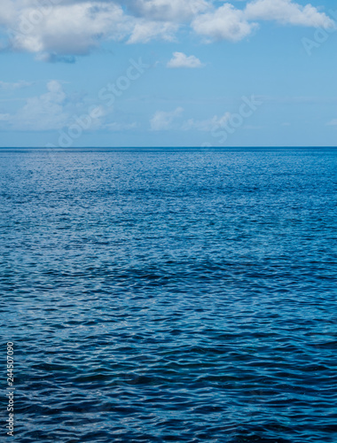 Deep blue Atlantic ocean seascape, with blue sky and clouds