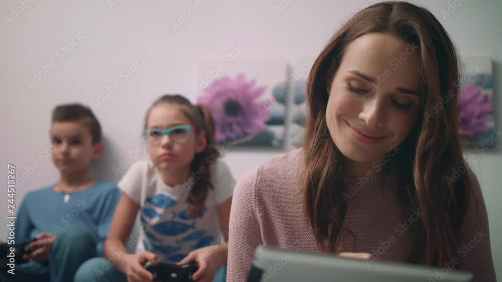 Close up of happy mother watching photo on tablet pc. Woman using tablet Close up of happy mother watching photo on tablet pc. Woman using tablet