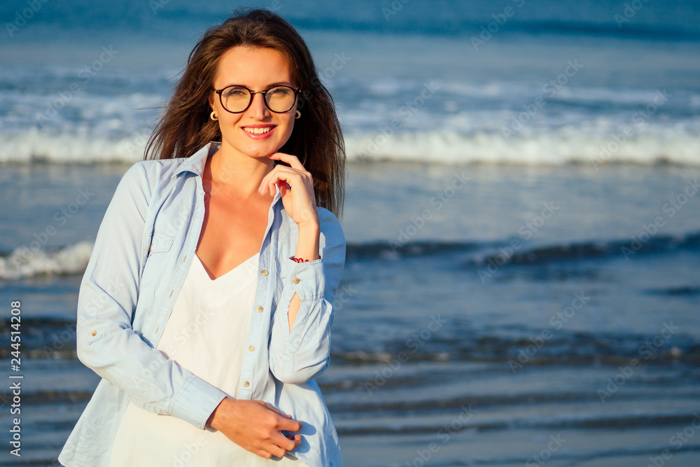 student business lady beach style .Woman tourist on tropical summer vacation wearing glasses, bag relaxing on travel holidays. Young lady luxury fashion blue shirt over white jersey top beachwear. student business lady beach style .Woman tourist on tropical summer vacation wearing glasses, bag relaxing on travel holidays. Young lady luxury fashion blue shirt over white jersey top beachwear.