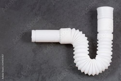 фотографія Plastic pipe with water trap, isolated - Plastic flexible siphon