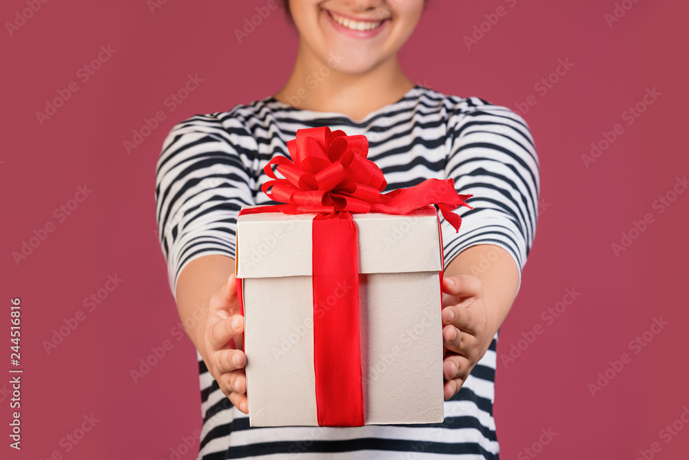 Cropped picture of girl with gift box isolated over pink background Cropped picture of girl with gift box isolated over pink background