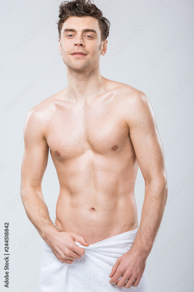 sexy handsome macho posing in towel isolated on grey sexy handsome macho posing in towel isolated on grey