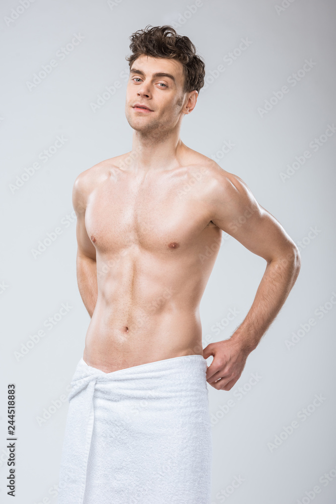 sexy muscular man posing in towel isolated on grey sexy muscular man posing in towel isolated on grey
