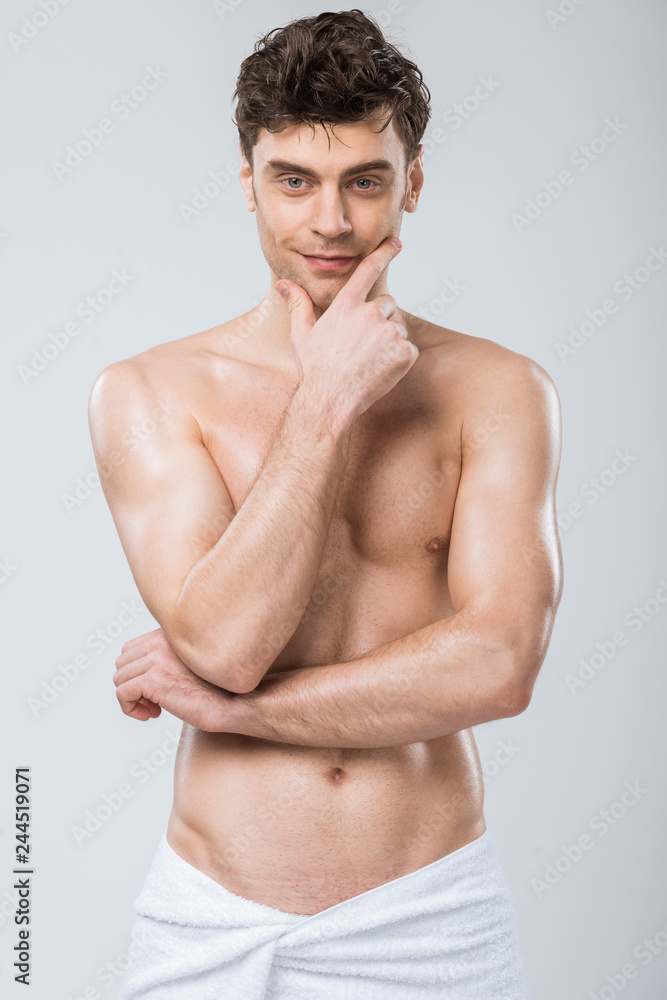 sexy shirtless man thinking in towel isolated on grey sexy shirtless man thinking in towel isolated on grey