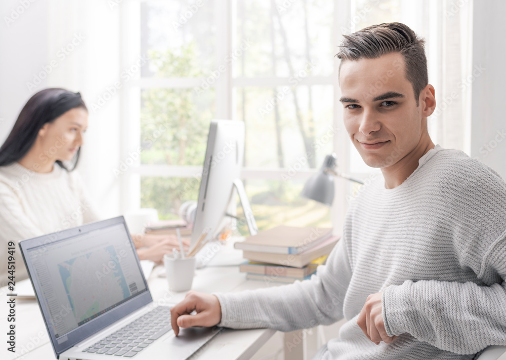 Confident male student posing and smiling Confident male student posing and smiling