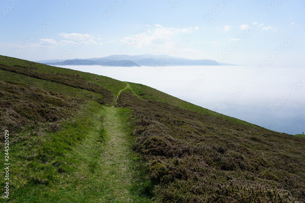Naklejka premium welsh countryside with clouds and mountains