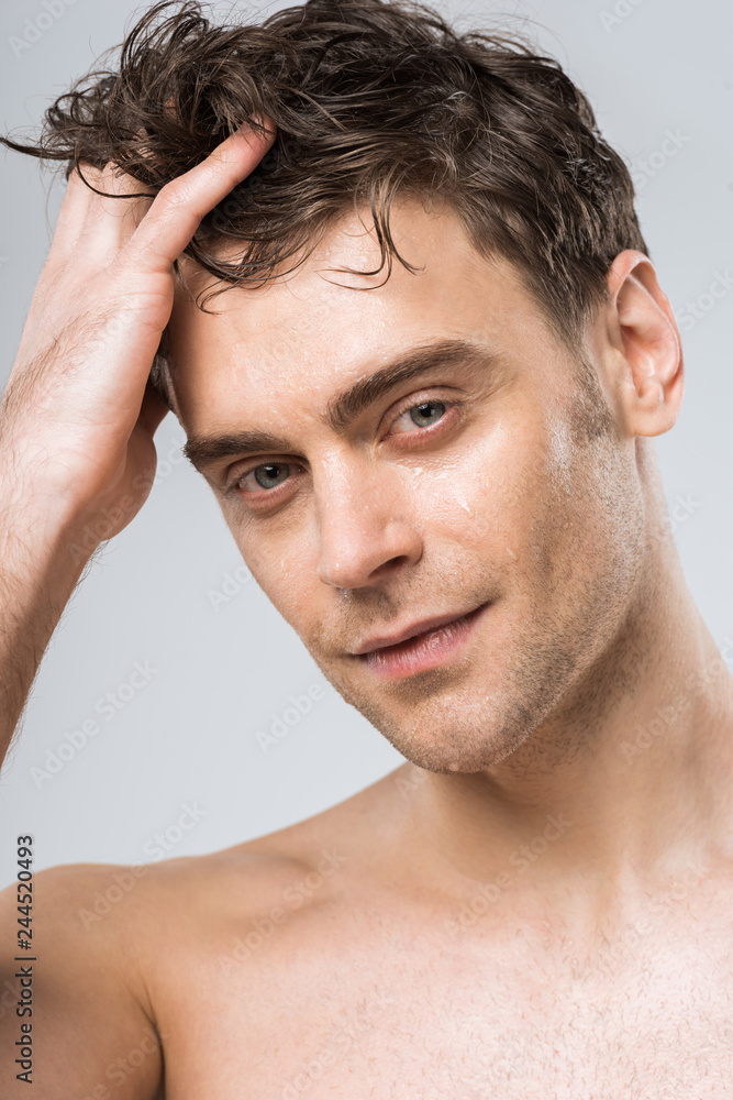 portrait of handsome young sexy man isolated on grey portrait of handsome young sexy man isolated on grey