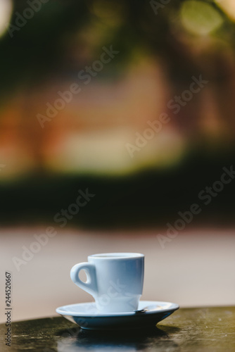 White coffee cup with defocused background and free space for text.