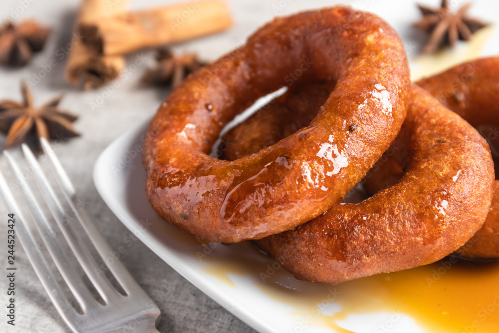 Peruvian classic dessert, picarones with honey Peruvian classic dessert, picarones with honey