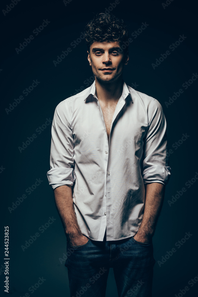 Obraz premium stylish handsome man posing in white shirt isolated on dark grey