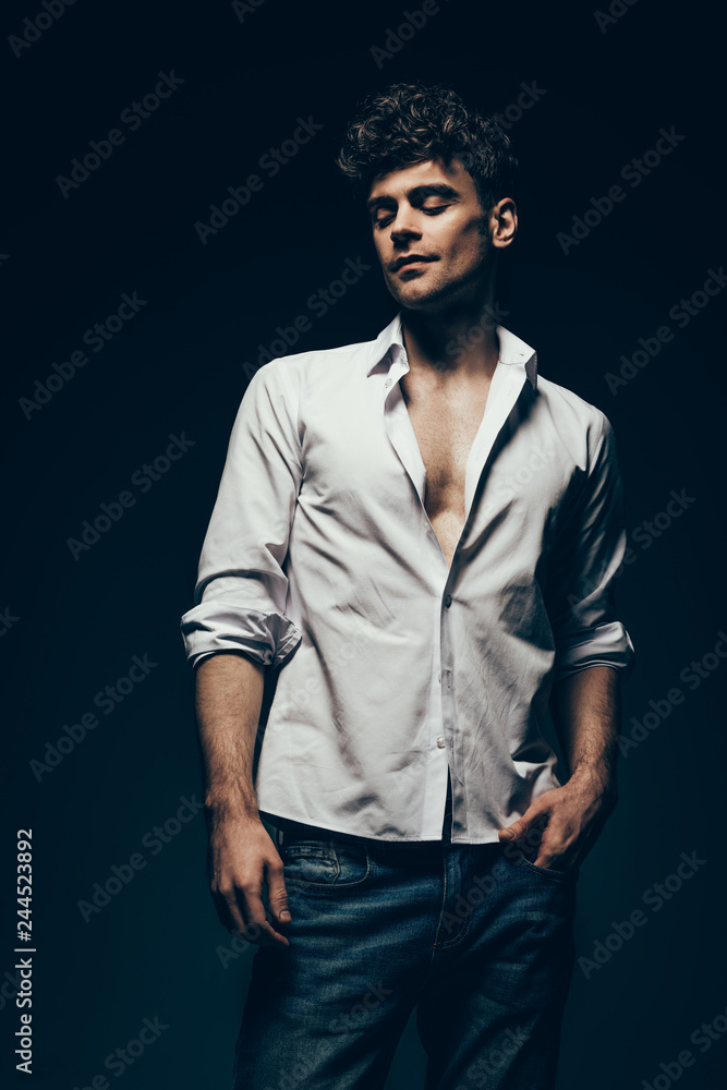 Obraz premium fashionable handsome man posing in white shirt isolated on dark grey