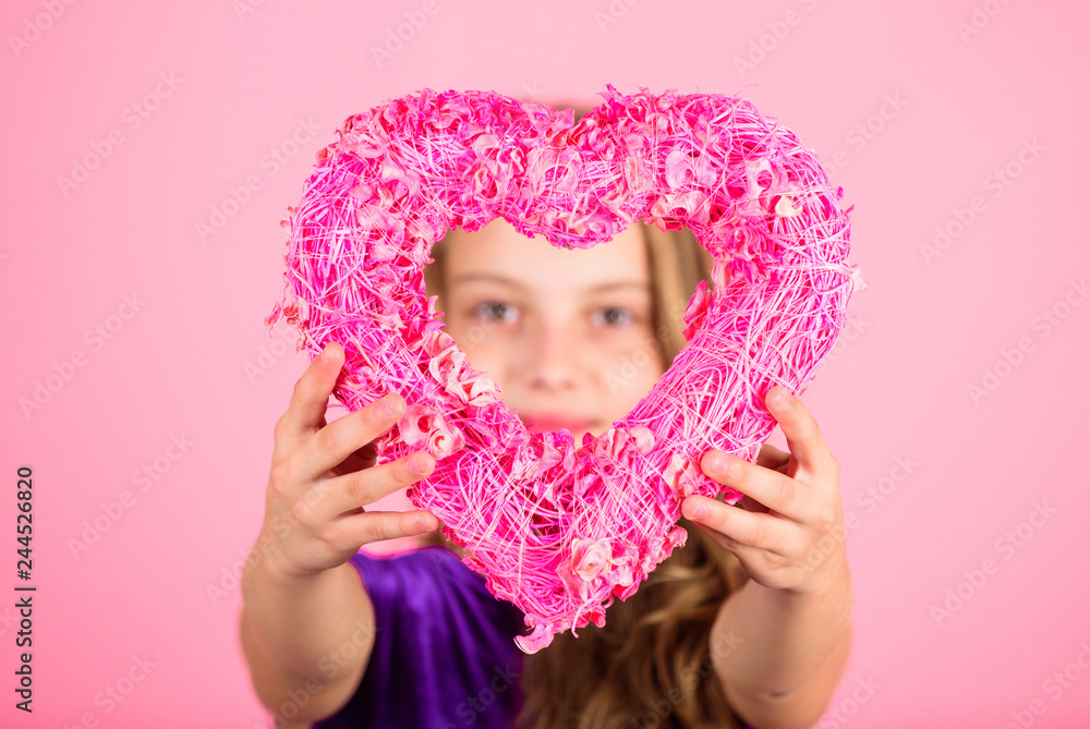 Love concept. Girl cute child show heart shaped decor. Symbol of love. Kid adorable girl with long hair happy face show heart to you. Look in heart part. Celebrate valentines day. Love holiday decor Love concept. Girl cute child show heart shaped decor. Symbol of love. Kid adorable girl with long hair happy face show heart to you. Look in heart part. Celebrate valentines day. Love holiday decor