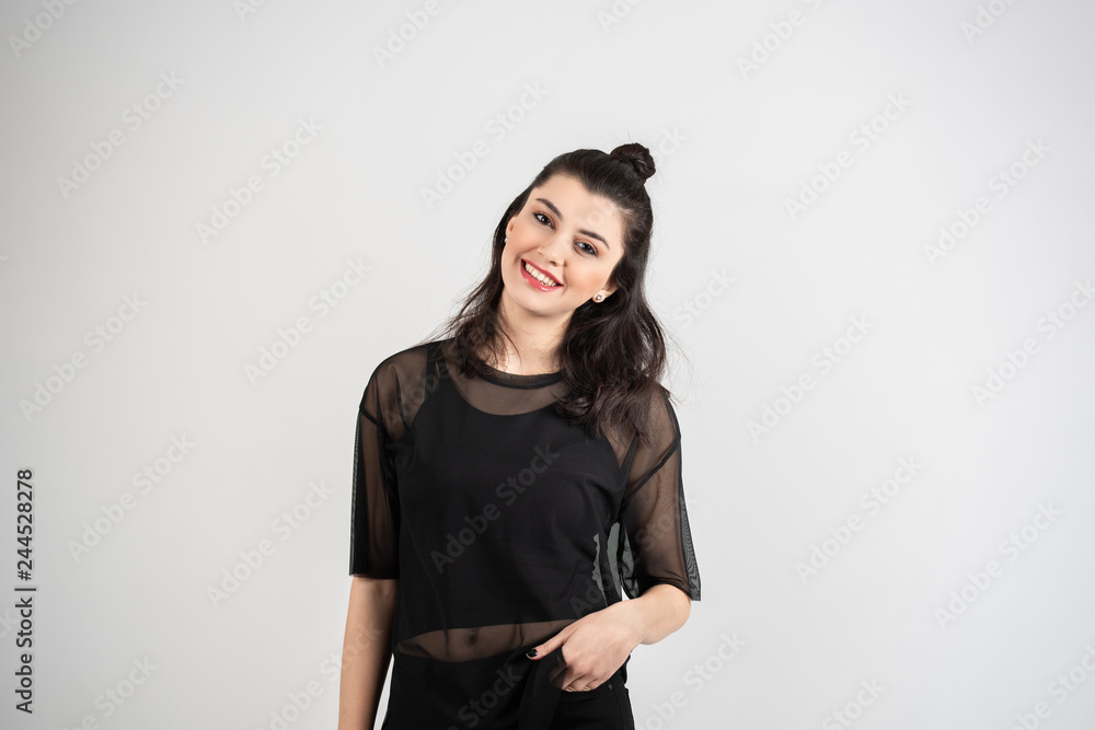 Happy cheerful young woman looking at camera with joyful and charming smile. Happy cheerful young woman looking at camera with joyful and charming smile.