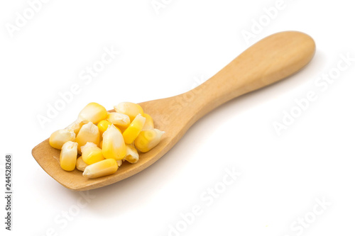 fresh sweet corn in wood spoon isolated