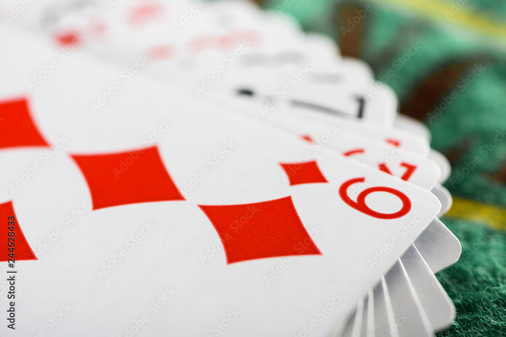 selective focus of playing card with diamonds suit in deck