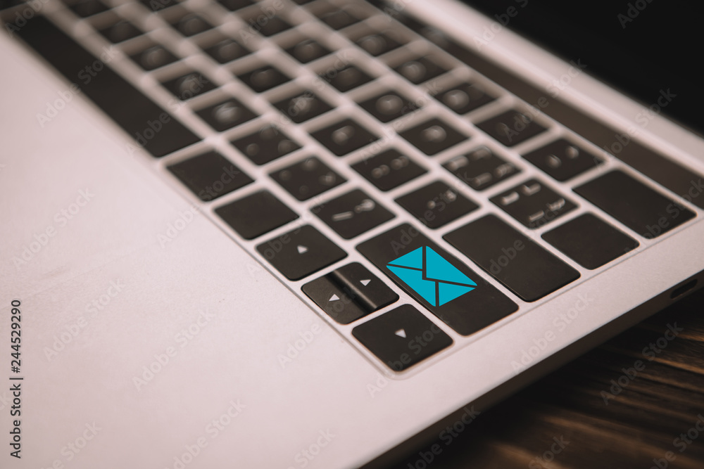 close up of laptop keyboard with email icon on button close up of laptop keyboard with email icon on button