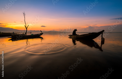 Fishermen find fish in the morning on the lake., Boat at sunset