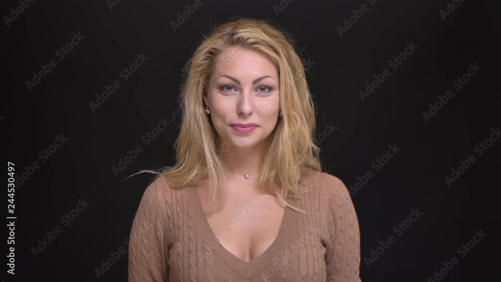 Portrait of joyful caucasian long-haired woman showing happy surprise into camera on black background. Portrait of joyful caucasian long-haired woman showing happy surprise into camera on black background.