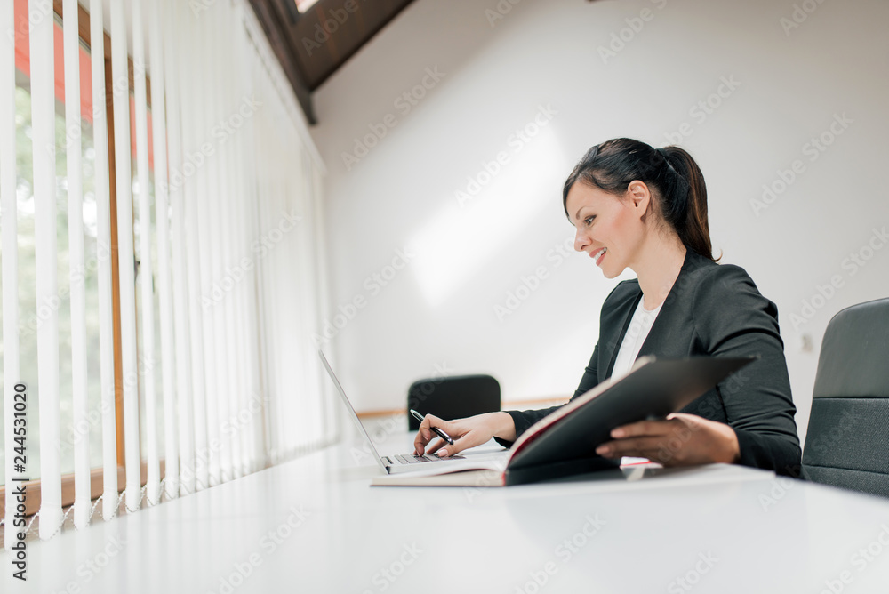 Side view of beautiful businesswoman working. Side view of beautiful businesswoman working.