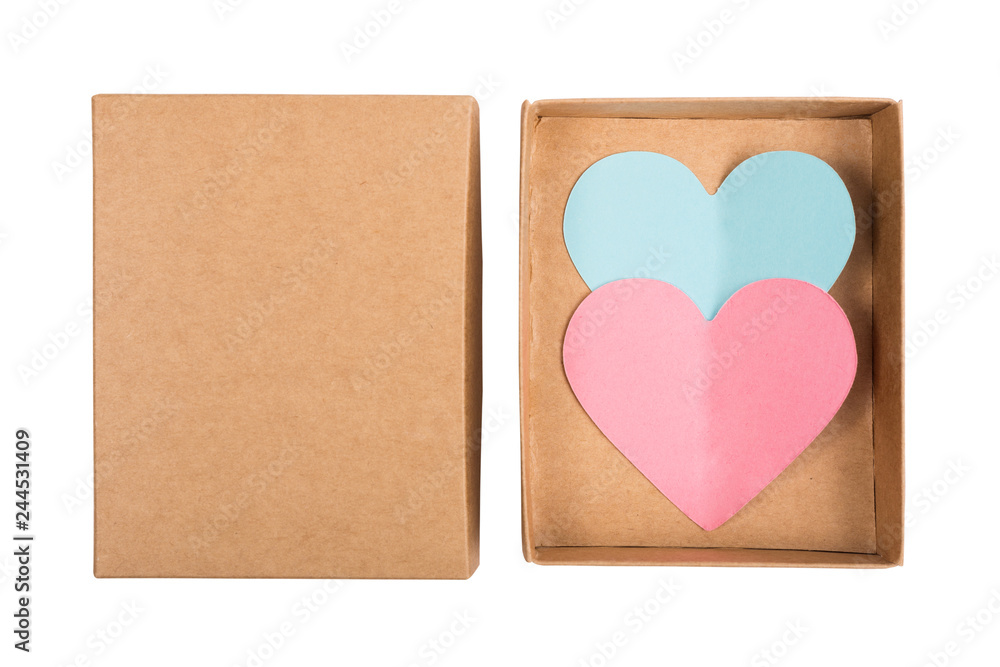 Above view on two paper hearts in cardboard box isolated on white background. Pink and blue hearts cut from paper in box