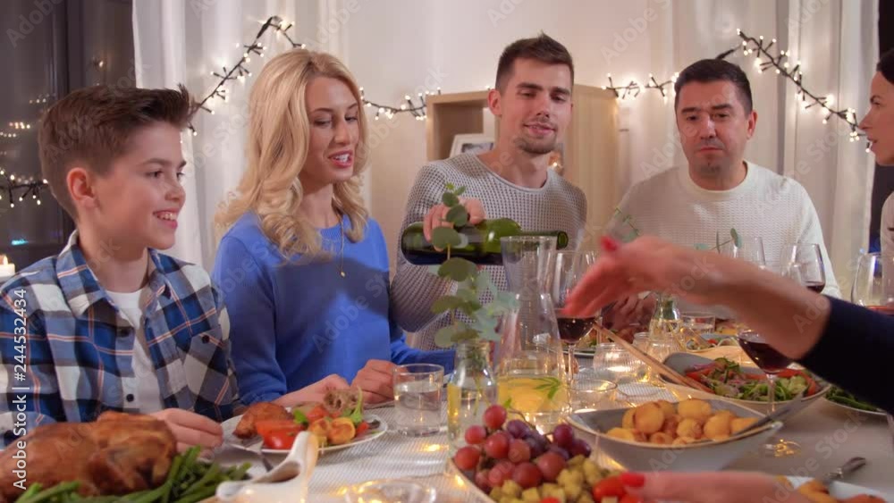 celebration, holidays and people concept - happy family having dinner party at home celebration, holidays and people concept - happy family having dinner party at home