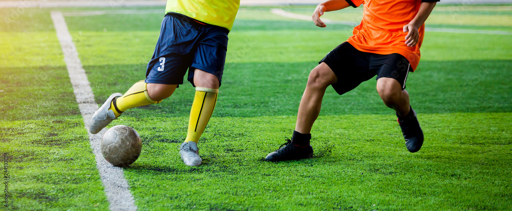 selective focus to kid soccer player speed run to control and shoot ball to goal. selective focus to kid soccer player speed run to control and shoot ball to goal.