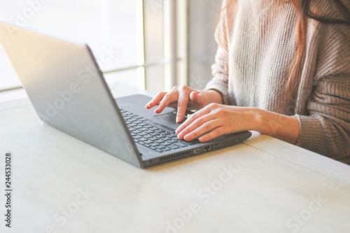 Woman working at home or office hands on keyboard laptop. Remote work freelance. Close-up.