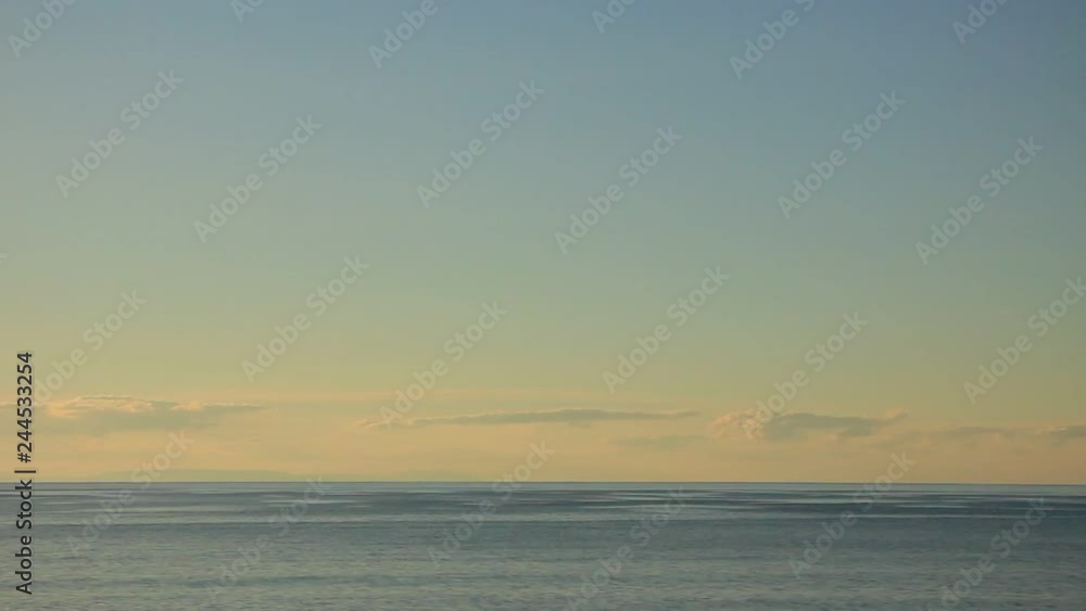 Calm sea water surface with clouds, time lapse