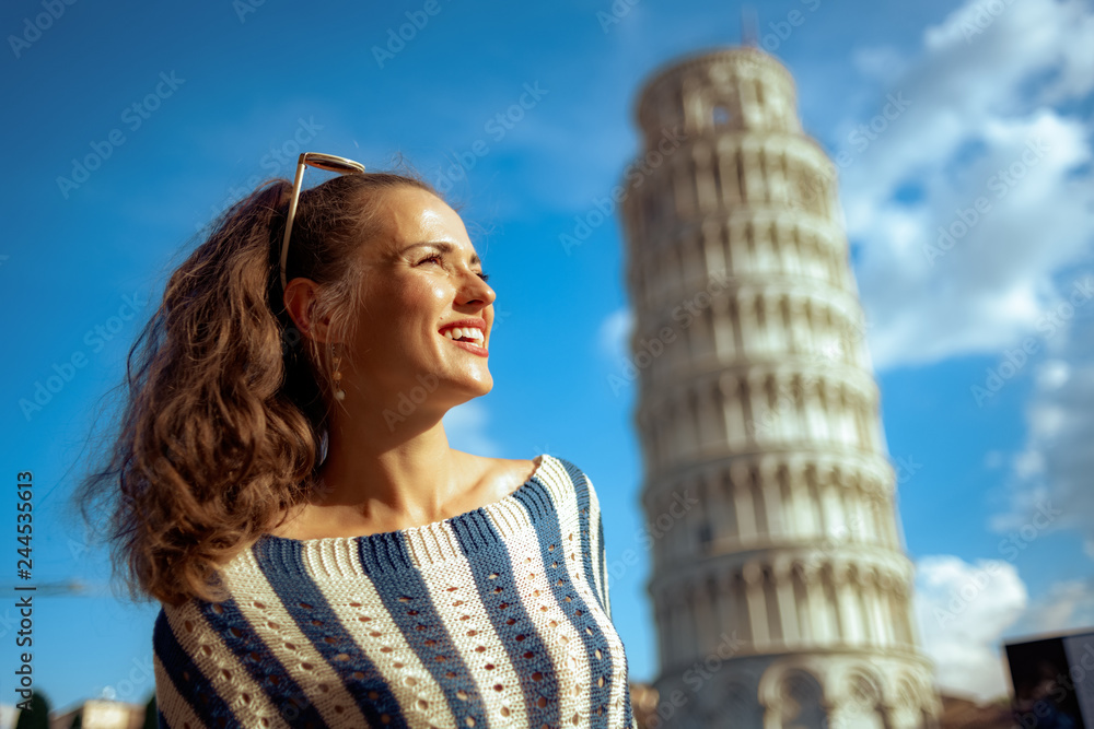 woman near leaning tower in Pisa, Italy looking into distance