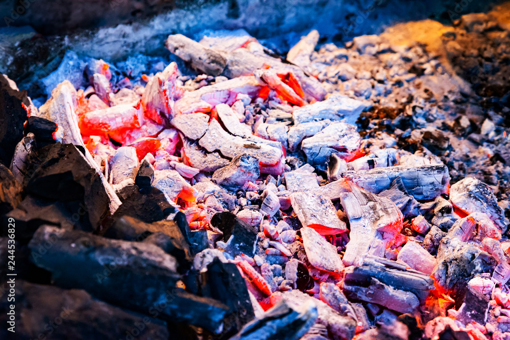 Hot coals for cooking barbecue. Bonfire with red hot flames. Textural ash and embers background.