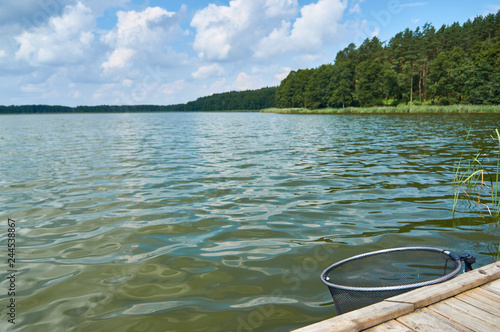 Fototapeta Naklejka Na Ścianę i Meble -  Empty footbridge over beautiful Lemiet lake in Mazury district, Poland. Fantastic travel destination.