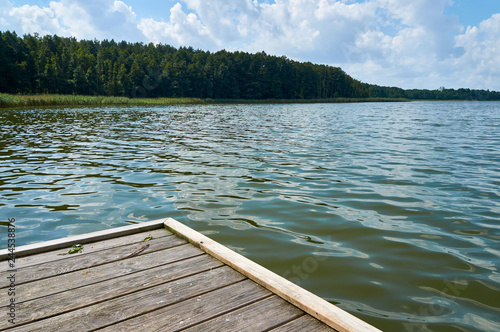 Fototapeta Naklejka Na Ścianę i Meble -  Empty footbridge over beautiful Lemiet lake in Mazury district, Poland. Fantastic travel destination.
