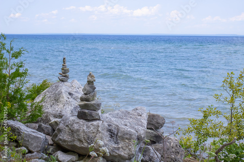 Rock Cairns On The Beach. Rock cairns on the rocky shoreline of Lake Huron on Mackinaw Island Michigan.