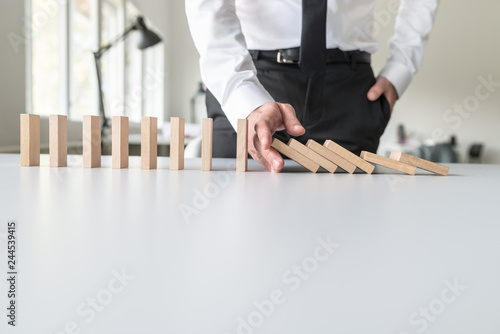 Obraz na płótnie Front view of business consultant stopping falling dominos